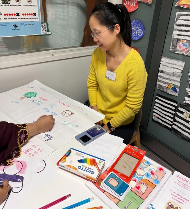 person writing and draving on paper.